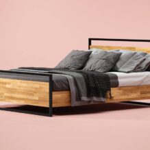 wood and metal bed on which there is bedding