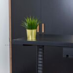 black desk and vertical cable strip
