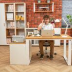white desk with a boy sitting and working at it