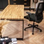 desk with wooden top and armchair next to it
