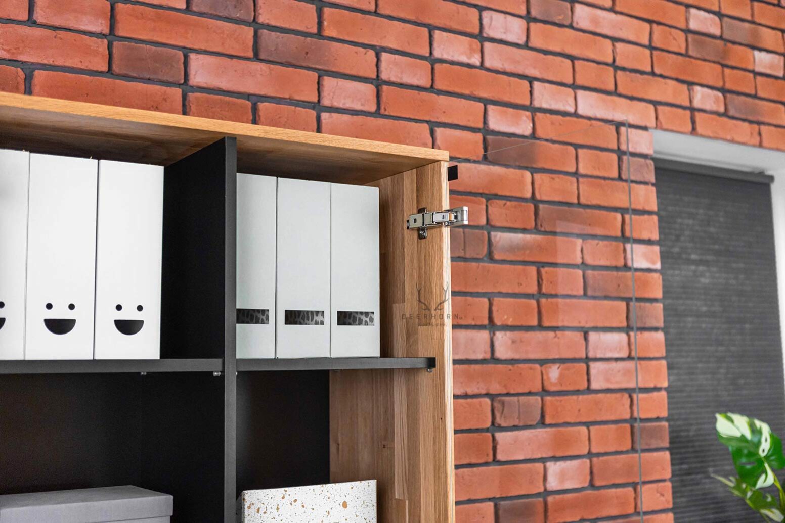 site-to-office glass showcase with black shelves