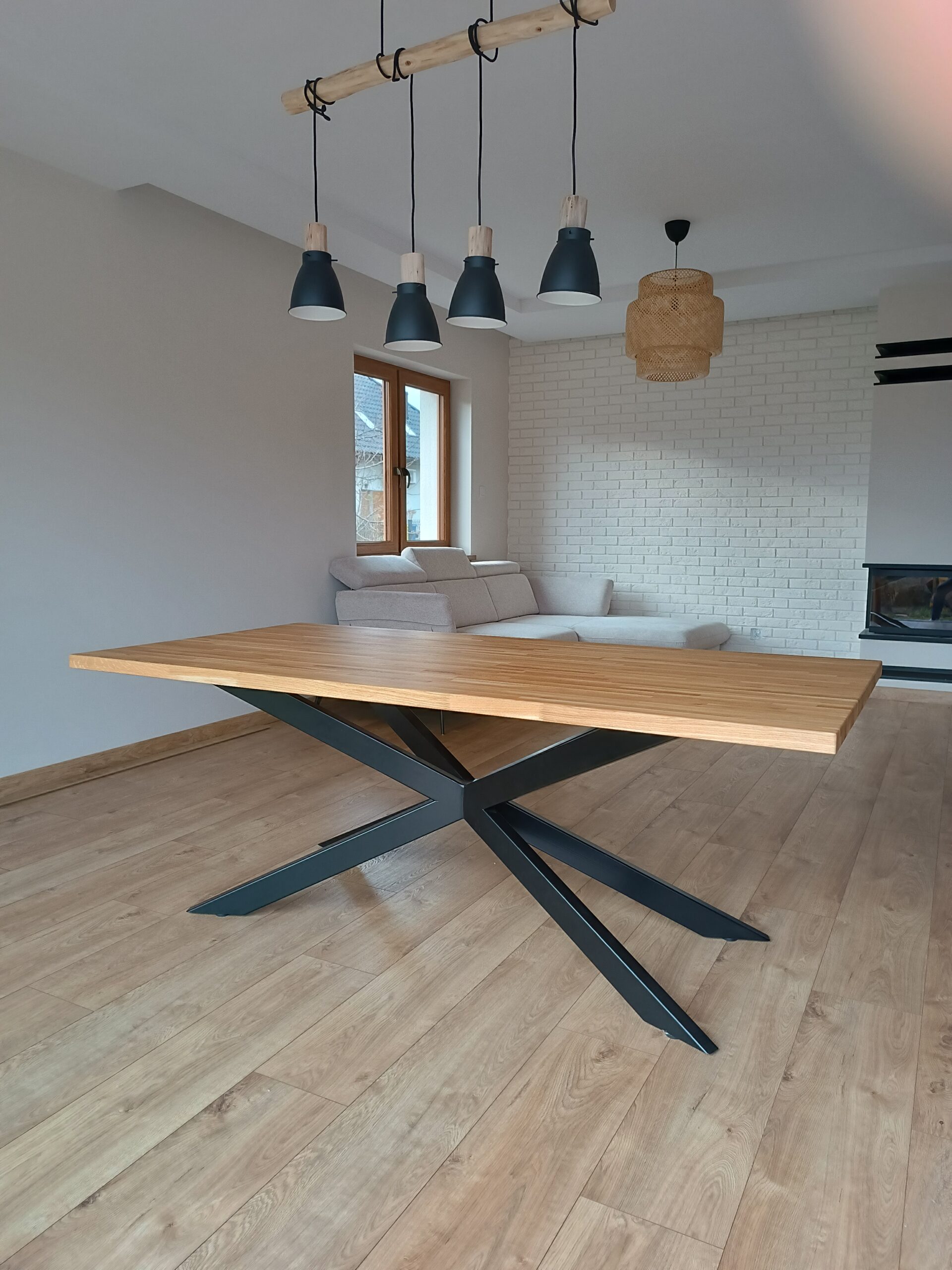 table with an oak top on a wide metal leg