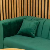 elegant sofa with cushions in bottle green color