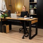 wooden desk top with black base