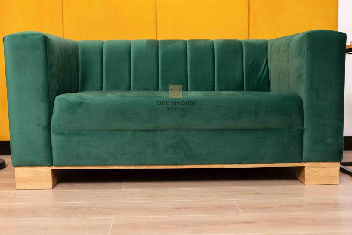 bottle-green sofa upholstered in soft velour