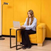 yellow armchair with wooden base