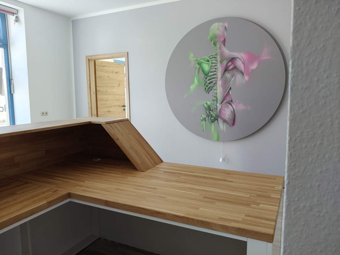 Layout of a corner reception desk in a small room with a decorative painting