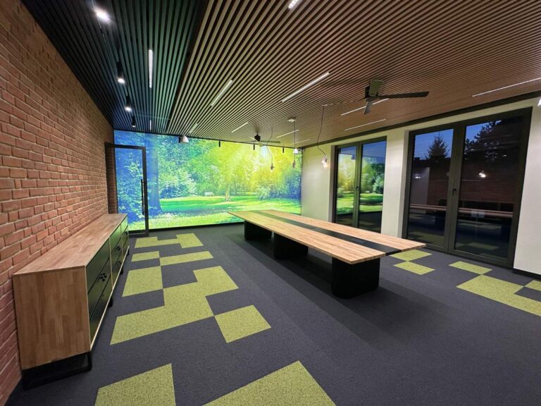 Large conference table in modern office with suspended ceiling