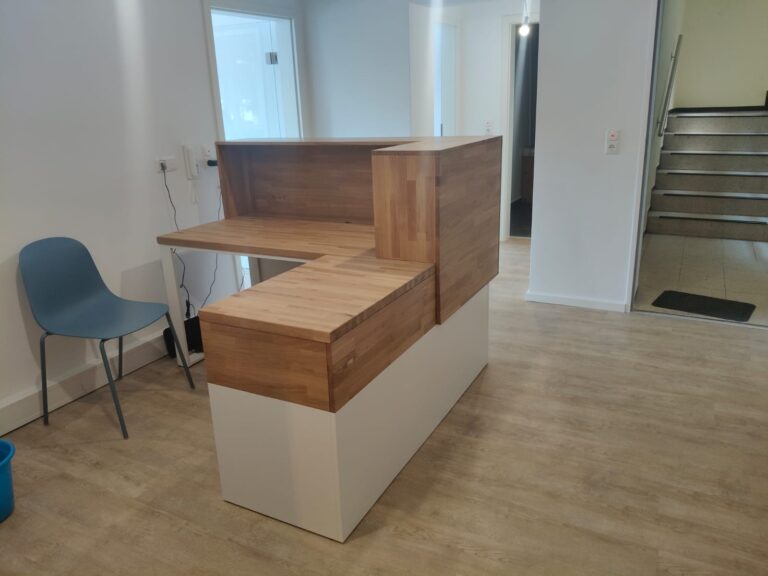 White reception counter for German company Gesundheit Wurmtal Praxis fur Ergotherapie