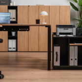Computer work desk with woodgrain surface and printer cabinet