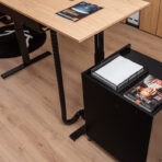 desk-lifting-with-container-working-with-laptop-in-office