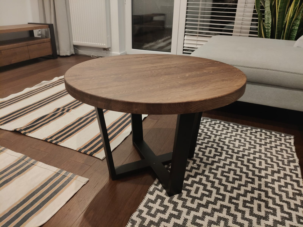 Round coffee table with dark wood top for the living room of a client from Lublin