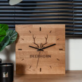 a clock with an engraving on wood