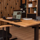 Wooden desk for working on a laptop—top view with office accessories