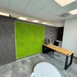 Modern Office corner desk by a green moss wall for ZERO driving school from Friedrichshafen (Germany)