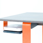 desk with an orange frame and space for a Mac mini