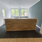 Reception desk with slats for the Physiotherapie Clouth physical therapy office in Mannheim, Germany