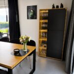 dining table with an oak tabletop and a display cabinet with LED lighting
