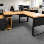 Desk with a cable pass-through for a computer