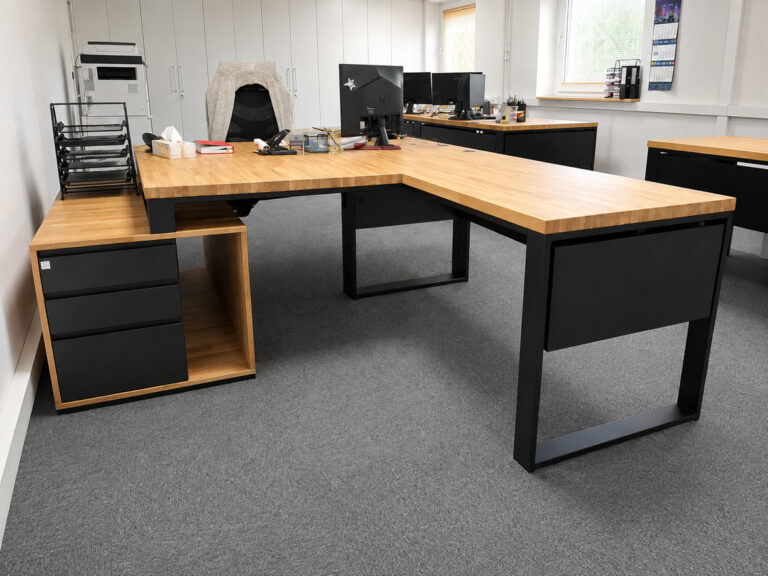 Desk with a cable pass-through for a computer