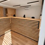 Large corner reception desk with wooden slats