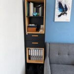 A narrow office bookcase with drawers