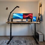 Electric desk with an oak tabletop for working on a computer in a home office