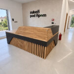 Wooden reception desk with black accents for a modern dental clinic