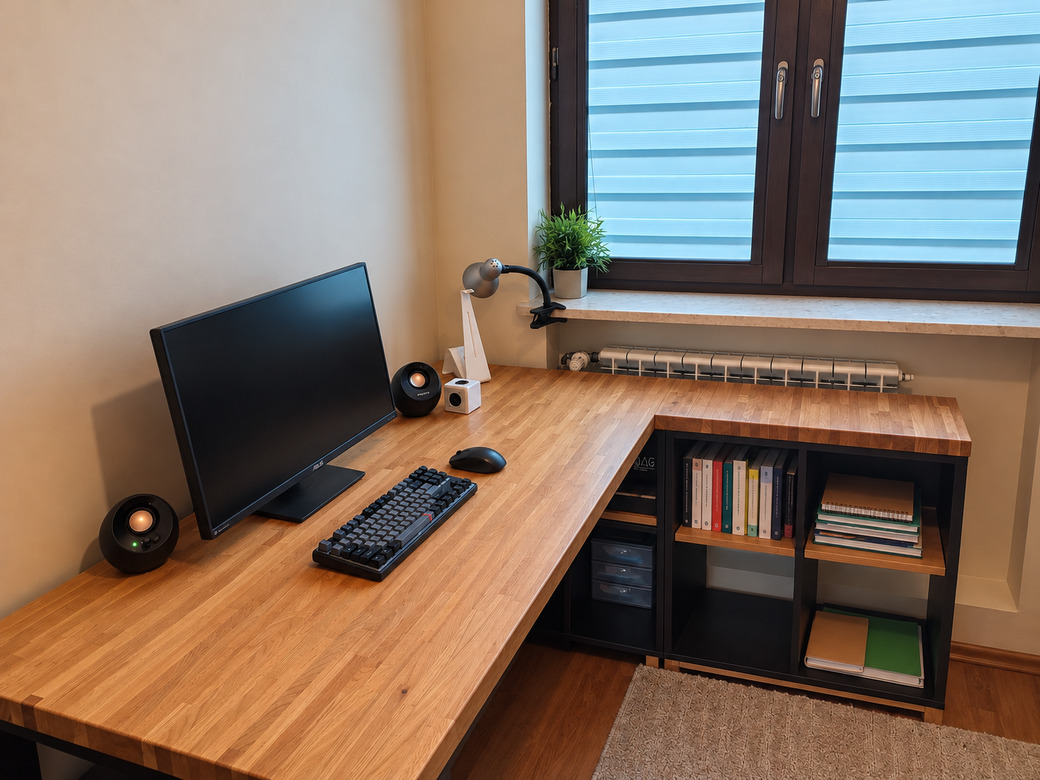 Wooden corner desk with shelves for a programmer working at a computer