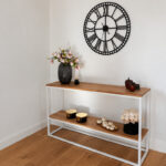 A minimalist white console table with wooden accents for a modern home interior