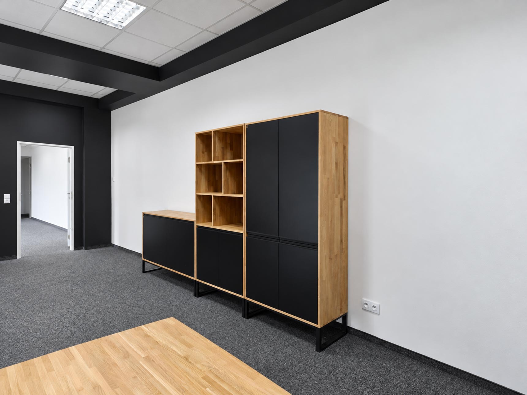 Minimalist office furniture featuring a bookcase, a chest of drawers, and a tall cabinet