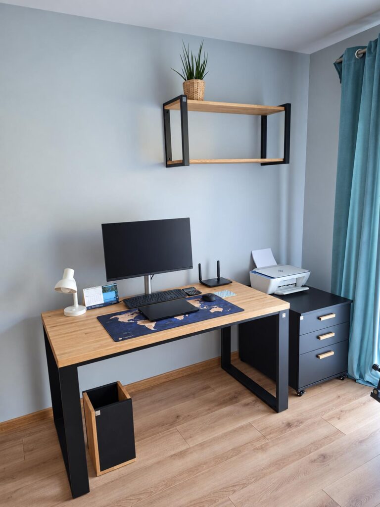 A modern workstation with an oak desk, a cabinet, and a wall shelf for a home office